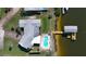 Aerial view of house, pool, and waterfront dock at 218 S Venetian Way, Port Orange, FL 32127