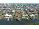 Aerial view showcases canal-front homes, each with private docks and boatlifts on the water at 218 S Venetian Way, Port Orange, FL 32127