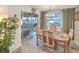 Charming dining area featuring a wooden table, chandelier, and sliding glass doors leading to a screened lanai with water views at 218 S Venetian Way, Port Orange, FL 32127