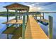 Picturesque waterfront dock featuring a covered area, offering a scenic place to relax by the water at 218 S Venetian Way, Port Orange, FL 32127