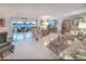 Open-concept living space with terrazzo flooring, connecting the sitting room, dining area, and sunroom at 218 S Venetian Way, Port Orange, FL 32127