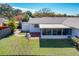 Overhead view of the backyard, brick patio, sunroom, and lush green lawn, perfect for entertaining at 2207 Winter Woods Blvd, Winter Park, FL 32792