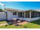 Charming backyard with a brick patio, perfect for enjoying the outdoors under clear skies at 2207 Winter Woods Blvd, Winter Park, FL 32792