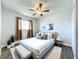 Staged bedroom featuring updated flooring, modern decor, a ceiling fan, and window with new window treatments at 2207 Winter Woods Blvd, Winter Park, FL 32792