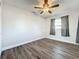 This bedroom has wood-look flooring, a ceiling fan, and a window to allow for natural light at 2207 Winter Woods Blvd, Winter Park, FL 32792