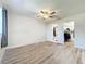 Airy bedroom with hardwood floors, ceiling fan, and an ensuite bathroom with closet at 2207 Winter Woods Blvd, Winter Park, FL 32792