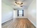 Large empty bedroom featuring wood floors, a ceiling fan, and natural light from the window at 2207 Winter Woods Blvd, Winter Park, FL 32792