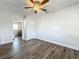 Bedroom with hardwood floors, ceiling fan, and view into adjacent room at 2207 Winter Woods Blvd, Winter Park, FL 32792