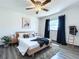 Bedroom with wood-look flooring, ceiling fan, and a large window providing plenty of natural light at 2207 Winter Woods Blvd, Winter Park, FL 32792