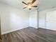 Neutral bedroom with modern ceiling fan, fresh paint, and wood-look floors at 2207 Winter Woods Blvd, Winter Park, FL 32792