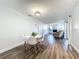 Bright dining area with white table and chairs, hardwood floors, and view into living room at 2207 Winter Woods Blvd, Winter Park, FL 32792