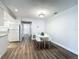 View of dining area, kitchen, and hallway with hardwood floors and white appliances at 2207 Winter Woods Blvd, Winter Park, FL 32792