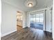 Dining area with wood-look floors, stylish light fixture, and sliding doors to the screened-in porch at 2207 Winter Woods Blvd, Winter Park, FL 32792