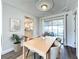 Bright dining room featuring luxury vinyl floors, modern ceiling and sliding glass doors leading to the patio at 2207 Winter Woods Blvd, Winter Park, FL 32792