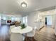 Open concept dining room with white table and kitchen view at 2207 Winter Woods Blvd, Winter Park, FL 32792