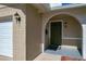 Green front door with brick columns and arched entryway at 2207 Winter Woods Blvd, Winter Park, FL 32792