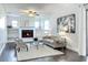 Cozy living room with a white brick fireplace, ceiling fan, and comfortable seating at 2207 Winter Woods Blvd, Winter Park, FL 32792