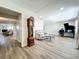 Spacious living room featuring hardwood floors, a piano, and ample natural light at 2207 Winter Woods Blvd, Winter Park, FL 32792