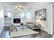 Cozy living room boasts a charming fireplace, modern furniture, and soft natural lighting at 2207 Winter Woods Blvd, Winter Park, FL 32792