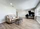 Bright living room with hardwood floors, a comfy couch, and a grand piano at 2207 Winter Woods Blvd, Winter Park, FL 32792