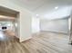 Bright, open-concept living room showcasing fresh paint, recessed lighting, and modern, wood-look floors at 2207 Winter Woods Blvd, Winter Park, FL 32792