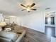 Spacious living room with hardwood floors, ceiling fan, and multiple areas for entertaining at 2207 Winter Woods Blvd, Winter Park, FL 32792