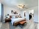 Stylish main bedroom featuring hardwood floors, ceiling fan, and an ensuite bathroom with closet at 2207 Winter Woods Blvd, Winter Park, FL 32792