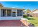 Brick patio with table and chairs, adjacent to sunroom at 2207 Winter Woods Blvd, Winter Park, FL 32792