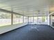 Bright sunroom featuring a ping pong table, ceiling fan, and large windows overlooking the backyard at 2207 Winter Woods Blvd, Winter Park, FL 32792