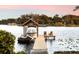 Wooden boat dock with covered boat slip and chairs at 2501 Jennifer Hope Blvd, Longwood, FL 32779