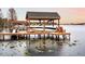 Boat dock with covered boat slip and chairs on the lake at 2501 Jennifer Hope Blvd, Longwood, FL 32779