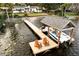 Aerial view of a boat dock with a boat and chairs at 2501 Jennifer Hope Blvd, Longwood, FL 32779