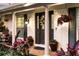 Front porch with brick flooring, dark brown door and planters at 2501 Jennifer Hope Blvd, Longwood, FL 32779