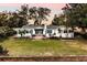 White house with large backyard and landscaping at 2501 Jennifer Hope Blvd, Longwood, FL 32779