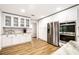 White kitchen with glass-front cabinets and stainless steel appliances at 2501 Jennifer Hope Blvd, Longwood, FL 32779