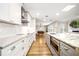 Modern kitchen with white cabinets, granite countertops, and game room view at 2501 Jennifer Hope Blvd, Longwood, FL 32779