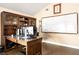 Home office with a large desk, built-in shelving, and a whiteboard at 2501 Jennifer Hope Blvd, Longwood, FL 32779