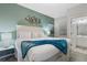 King-size bed with teal blanket and stylish decor at 2628 Calistoga Ave, Kissimmee, FL 34741