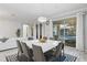 Modern dining room with white table and gray chairs, pool view at 2628 Calistoga Ave, Kissimmee, FL 34741