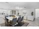 Open concept dining room with modern chandelier and white table at 2628 Calistoga Ave, Kissimmee, FL 34741