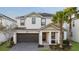 Two-story house with gray roof, white walls, and a two-car garage at 2628 Calistoga Ave, Kissimmee, FL 34741