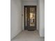 Modern dark brown front door with glass panels and a small welcome mat at 2628 Calistoga Ave, Kissimmee, FL 34741