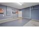 Neat and spacious garage with gray walls, epoxy flooring, and decorated with wall art at 2628 Calistoga Ave, Kissimmee, FL 34741