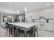 Modern kitchen with large island, quartz countertops, stainless steel appliances, and pendant lighting at 2628 Calistoga Ave, Kissimmee, FL 34741