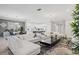 Bright living area with large white sectional, contemporary decor, and view of the kitchen at 2628 Calistoga Ave, Kissimmee, FL 34741