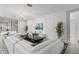 Chic living room features a large white sectional sofa, textured wall, and contemporary decor at 2628 Calistoga Ave, Kissimmee, FL 34741