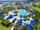 Stunning aerial view of the community pool surrounded by lush landscaping and comfortable seating areas at 2628 Calistoga Ave, Kissimmee, FL 34741