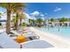 Resort-style pool featuring lounge chairs, tropical palm trees, and playful water fountains, perfect for relaxation at 2628 Calistoga Ave, Kissimmee, FL 34741