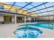 Stunning screened-in pool and spa with an entertainment area, perfect for relaxing in the Florida sunshine at 2628 Calistoga Ave, Kissimmee, FL 34741