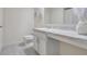 Clean bathroom, featuring a vanity with marble top and toilet at 2711 Angel Mist Ct, Mascotte, FL 34753